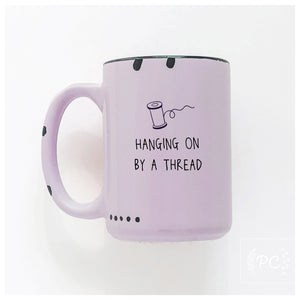 hanging on by a thread | ceramic mug