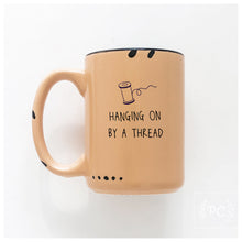 hanging on by a thread | ceramic mug