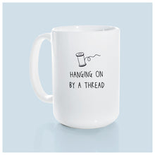 hanging on by a thread | ceramic mug