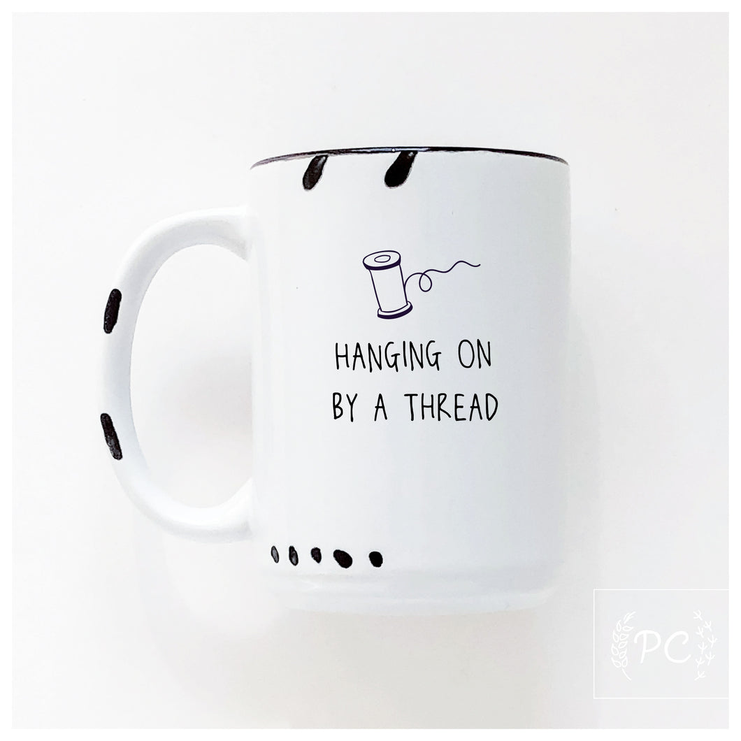 hanging on by a thread | ceramic mug