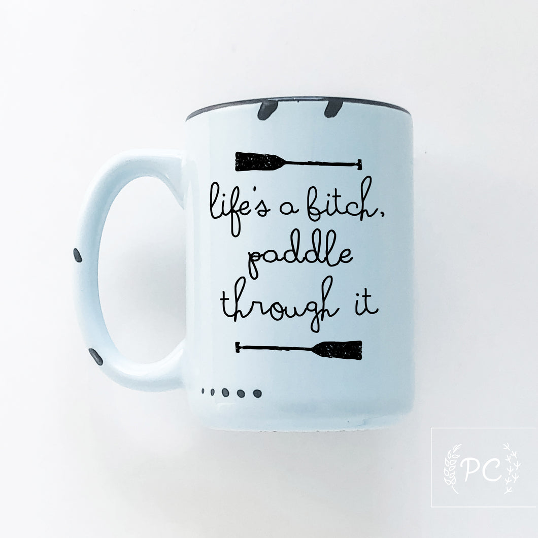 life's a bitch paddle through it | ceramic mug